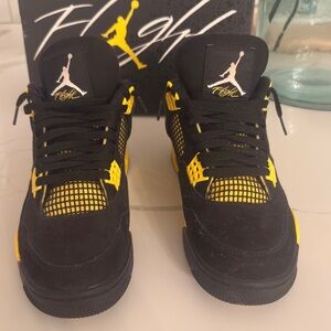 Jordan Four Thunders. Black and Yellow Sneakers.